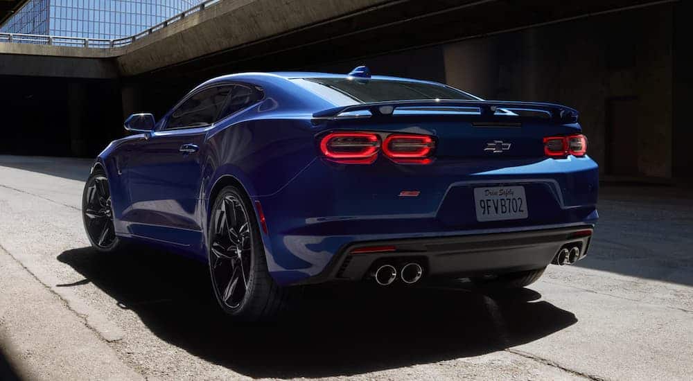 A blue 2021 Chevy Camaro 2SS is shown from the rear parked at an underpass.