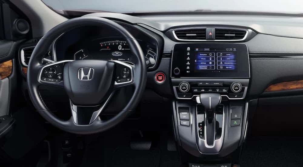 The steering wheel and infotainment system is shown on a 2021 Honda CR-V.