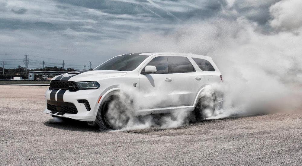 A white 2021 Dodge Durango is burning out on a track after getting performance parts at a California Dodge dealer.