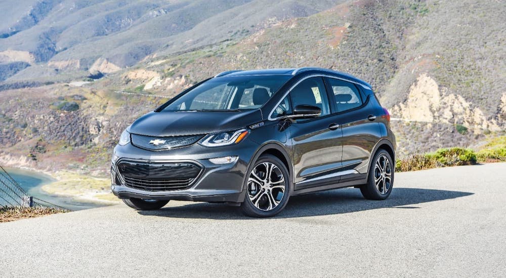 A black 2020 Chevy Bolt EV is parked on a hill.