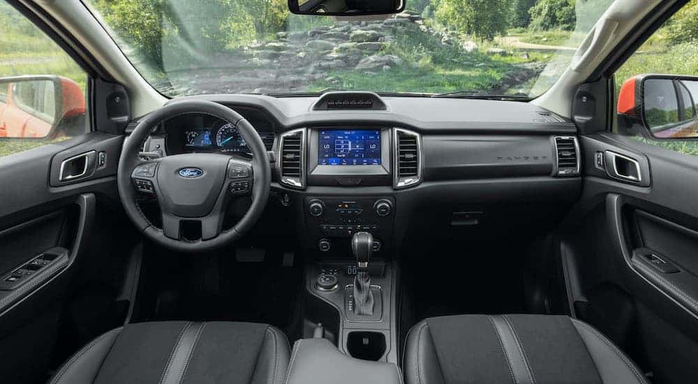 The black interior and infotainment system is shown on a 2021 Ford Ranger Tremor Lariat.