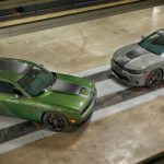 A green 2019 Dodge Challenger and a silver 2019 Dodge Charger are shown from above on a tile floor.