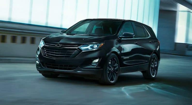 A black 2021 Chevy Equinox is driving through a tunnel.