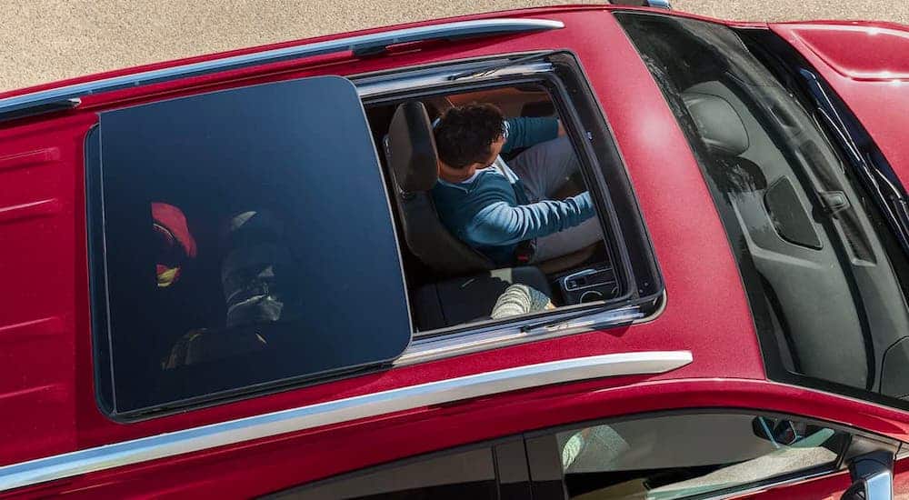 A high angle is showing the moon roof of a red 2021 Chevy Equinox.
