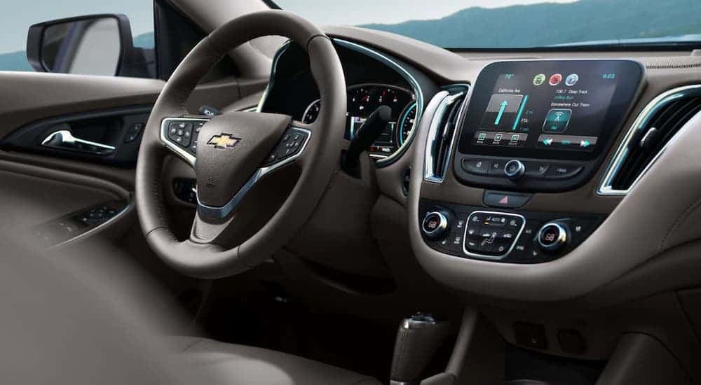 A closeup shows the infotainment screen and steering wheel in a 2021 Chevy Malibu.