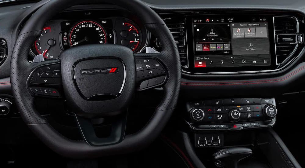 A closeup shows the black steering wheel and dashboard in a 2021 Dodge Durango.