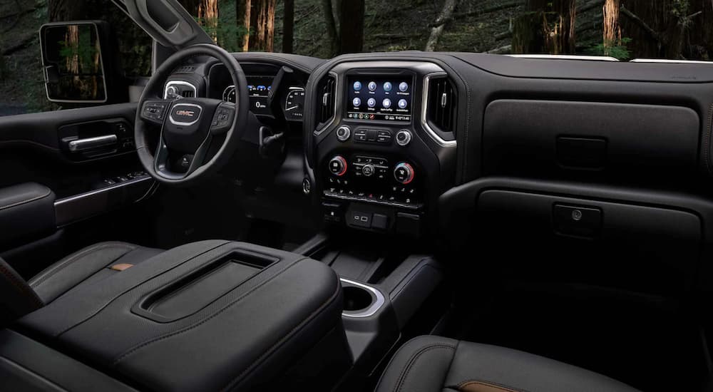 The black interior of a 2021 GMC Sierra 2500HD AT4 is shown.