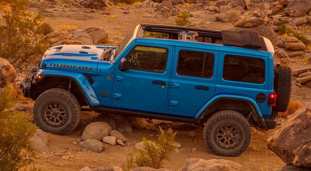 A blue 2021 Jeep Wrangler Rubicon 392 is shown from the side in the desert.