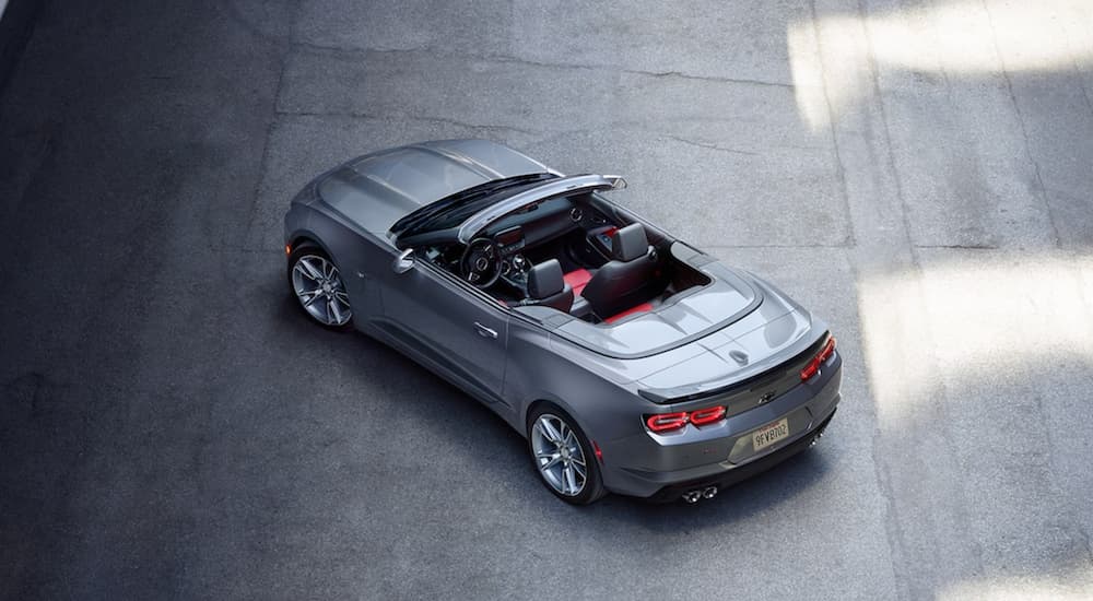 A grey 2021 Chevy Camaro 3LT convertible is shown from a high angle parked on concrete.