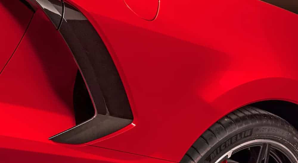 A close up shows the black fender vents on a red 2021 Chevy Corvette.