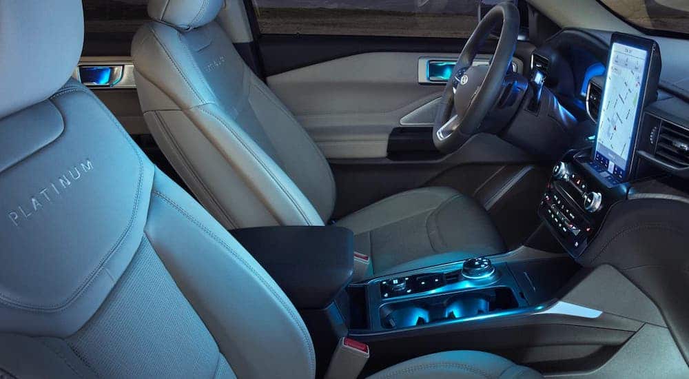 The interior front seats of a 2021 Ford Explorer Platinum are shown from the side.