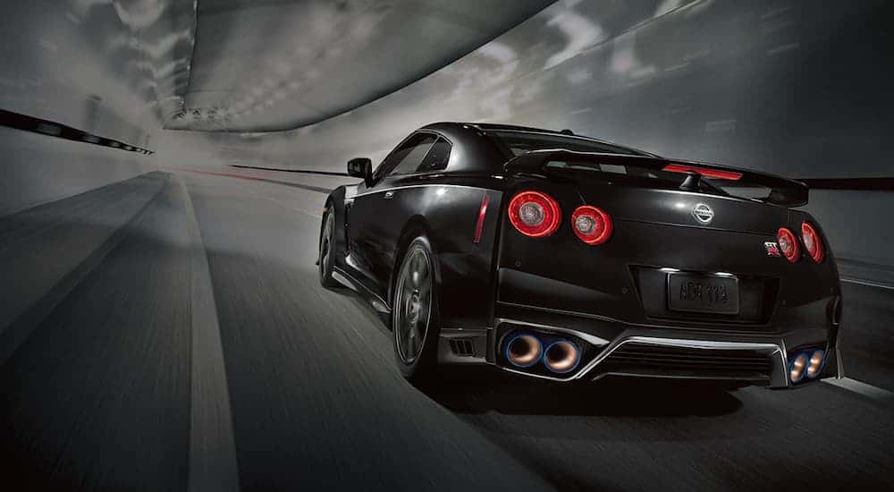 A black 2021 Nissan GT-R is shown from behind driving down a tunnel after leading a Hendersonville Nissan dealer.