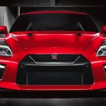 A red 2021 Nissan GT-R is shown from the front parked under a street light.
