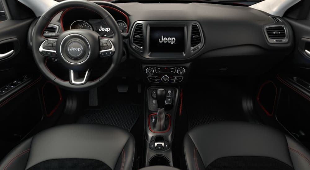 The black interior of a 2021 Jeep Compass Trailhawk is shown.