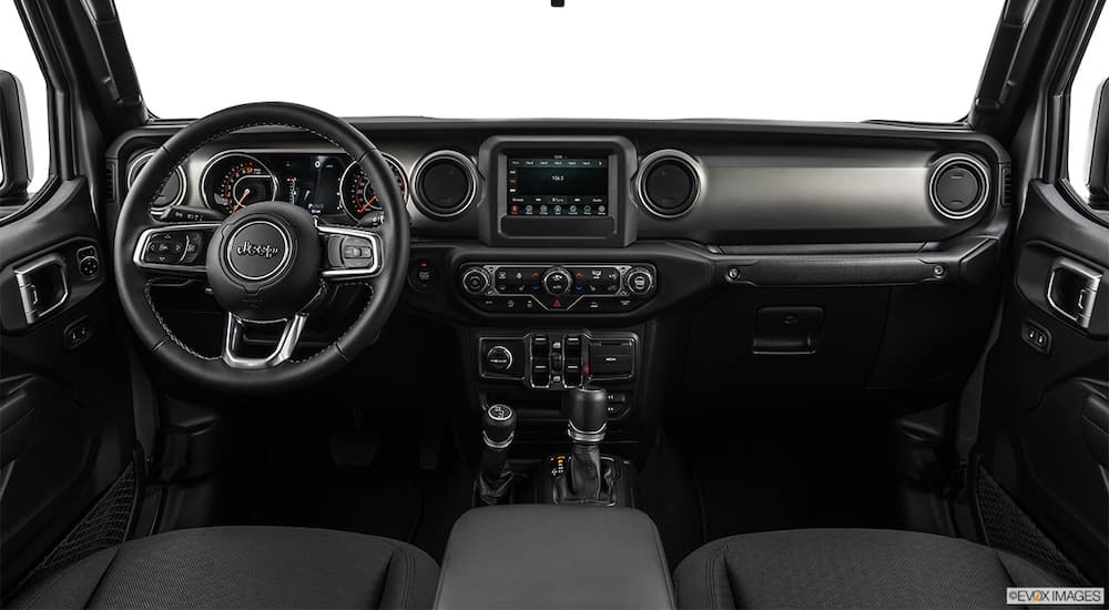The dashboard and screen in a 2020 used Jeep Gladiator Sport are shown.