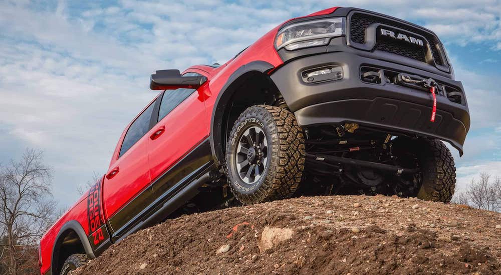 A red 2021 Ram 2500 Power Wagon is shown from a low angle parked on top of a dirt pile.