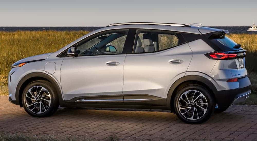 A silver 2022 Chevy Bolt EUV is shown from the side parked near the ocean.