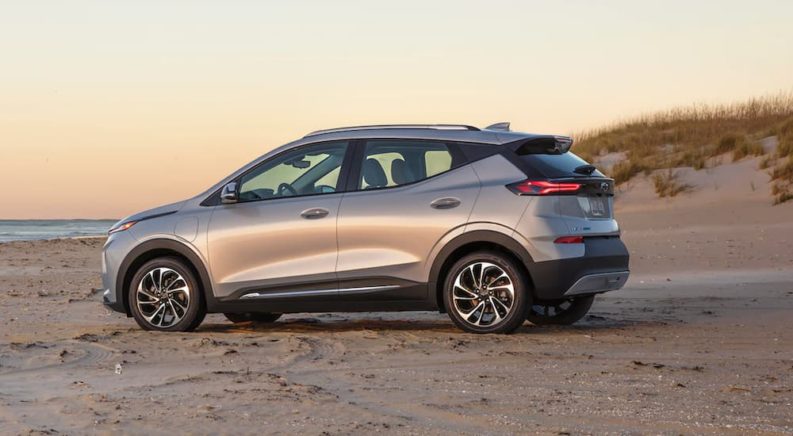 A silver 2022 Chevy Bolt EUV is parked on the beach after winning a 2022 Chevy Bolt EUV vs 2021 Ford Mustang Mach-E comparison.