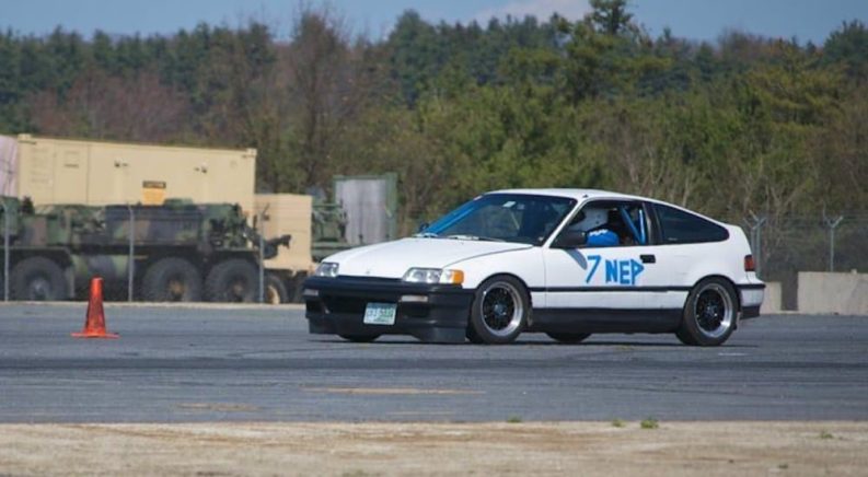 A white 1991 Honda CRX is shown driving past autocross cones.