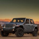 A silver 2021 Jeep Wrangler Unlimited 4xe is parked in a desert.