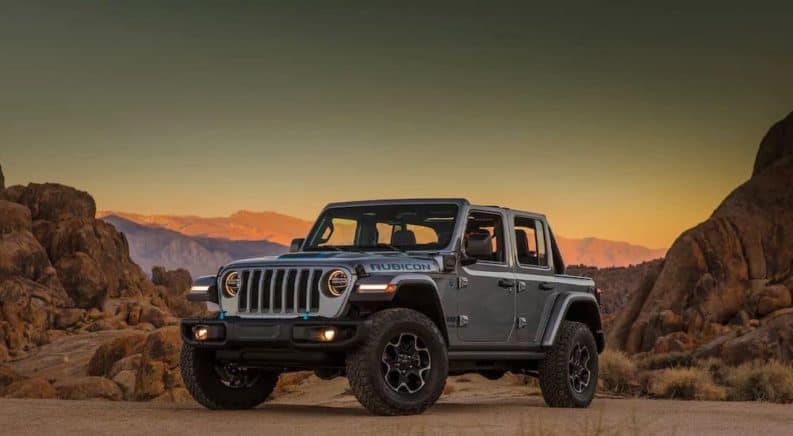 A silver 2021 Jeep Wrangler Unlimited 4xe is parked in a desert.