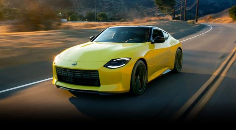 A yellow 2021 Nissan Proto Z is shown driving down the highway after leaving a Nissan dealership.