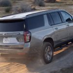 A silver 2021 Chevy Suburban is shown driving through the desert after leaving a Texas Chevy dealer
