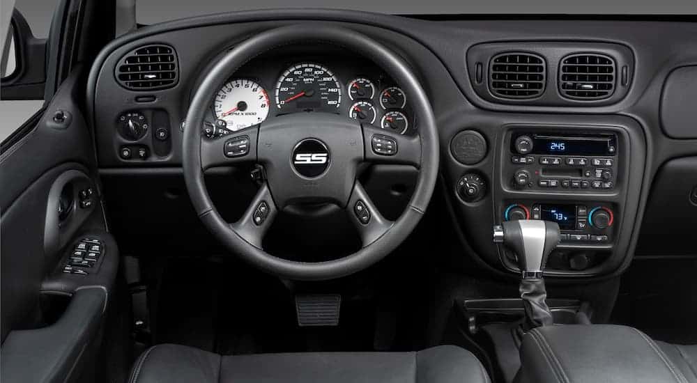 A close up shows the steering wheel and center console in a 2006 used Chevy Trailblazer SS.