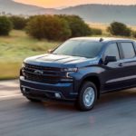 A blue 2021 Chevy Silverado 1500 RST is driving on an empty highway after winning the 2021 Chevy Silverado 1500 vs 2021 Toyota Tundra comparison.