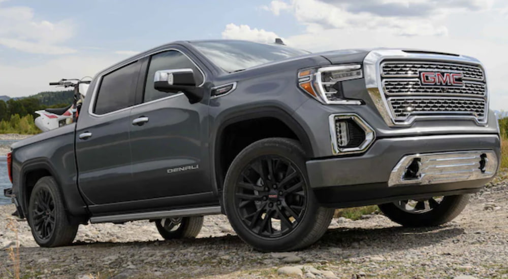 a grey 2021 GMC Sierra is shown from the side parked in a sand pit.