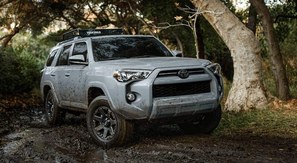 A silver 2021 Toyota 4Runner is off-roading in the mud. 