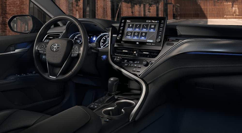 The black interior and dashboard of a 2021 Toyota Camry are shown.