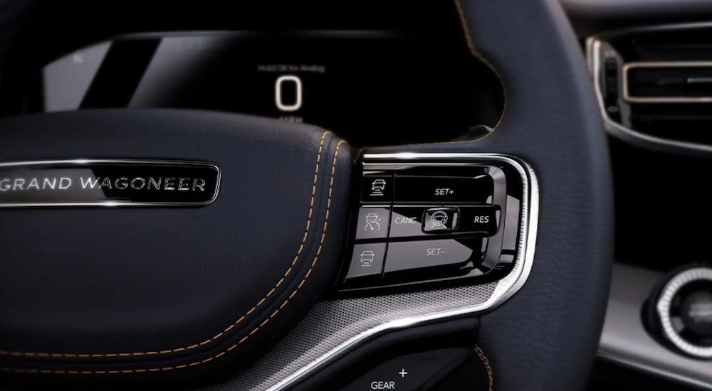 The interior of a 2022 Jeep Grand Wagoneer shows an advanced steering wheel. 