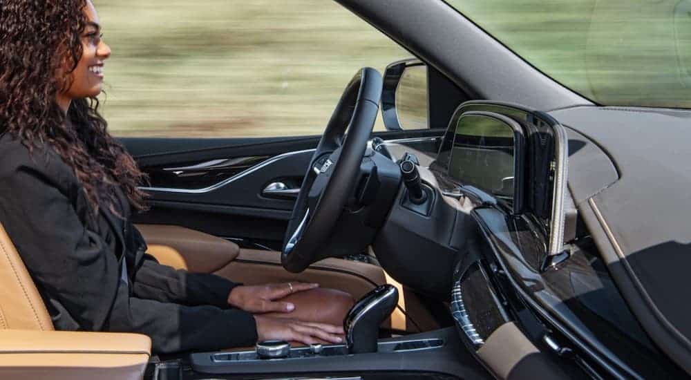 A woman is driving hands-free in a 2021 Cadillac Escalade with Super Cruise.