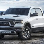 A white 2021 Ram 1500 Rebel is parked on top of a mountain.