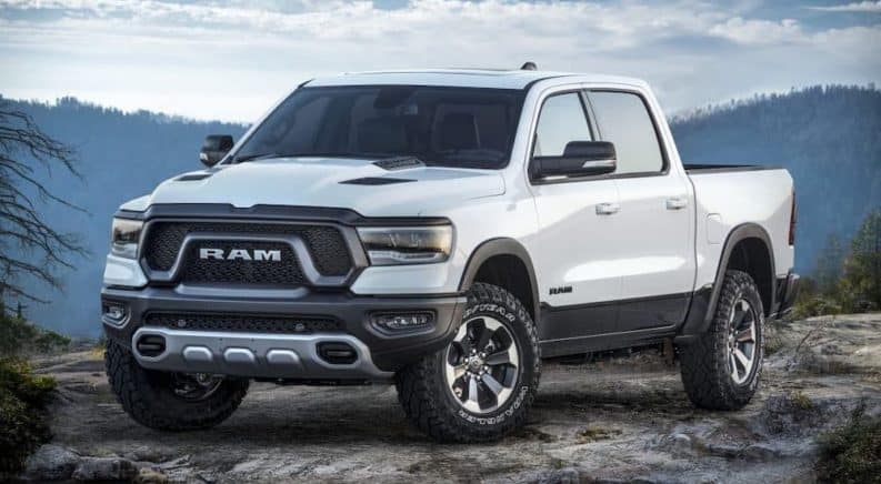 A white 2021 Ram 1500 Rebel is parked on top of a mountain.