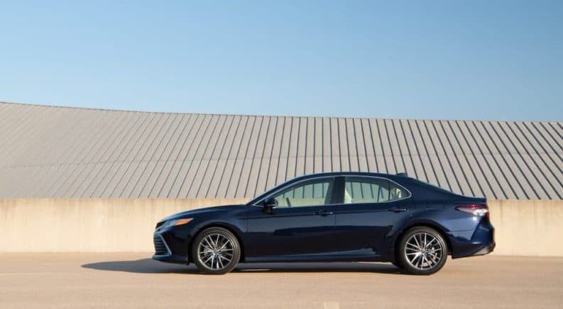 A dark blue 2021 Toyota Camry is shown from the side on a roof.