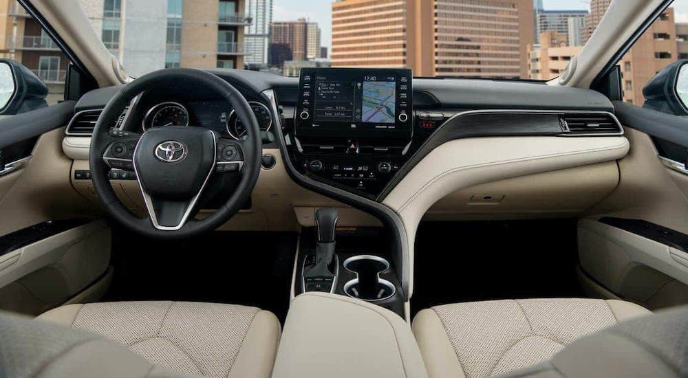 The tan and black dashboard is shown in a 2021 Toyota Camry.