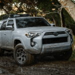 A white 2021 Toyota 4Runner is shown from an angle off roading after leaving a used car dealer.
