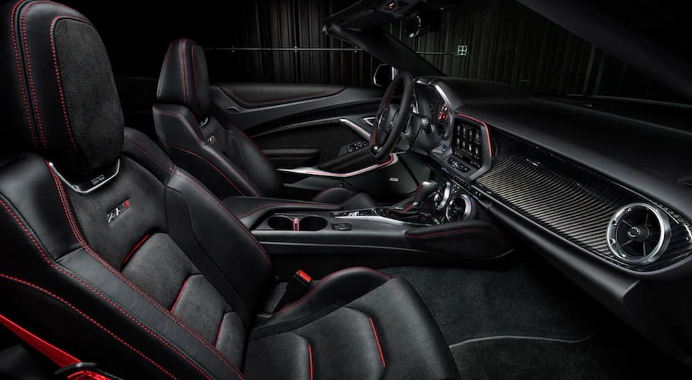 The interior 2021 Chevy Camaro ZL1 shows two front seats and the steering wheel.