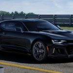 A black 2021 Chevy Camaro ZL1 is parked on a racetrack.