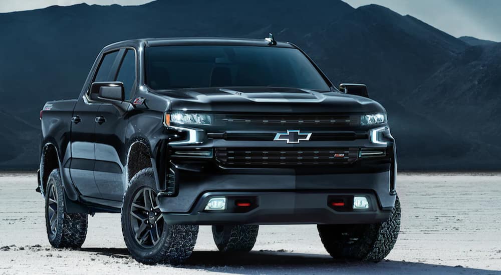 A black 2021 Chevy Silverado is shown from the front parked in the desert.