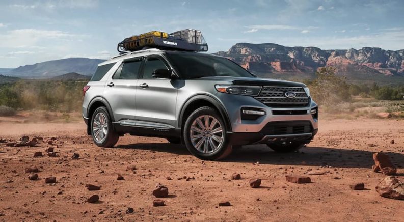 A silver 2021 Ford Explorer is parked in the desert after winning a 2021 Ford Explorer vs 2021 Jeep Grand Cherokee comparison.