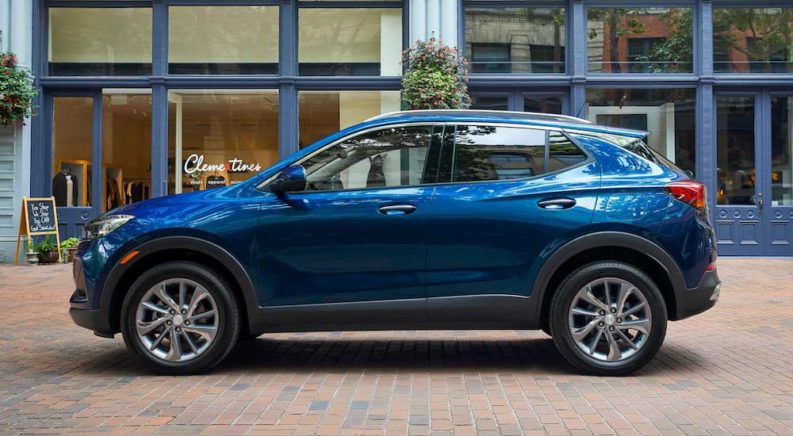 A blue 2021 Buick Encore is parked outside of a store after leaving a Buick Dealership.