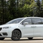 A white 2021 Chrysler Pacifica is parked in a lot in front of trees after leaving a Chrysler dealer near you.
