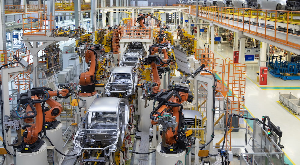 Car bodies are being assembled in production line at a modern plant.