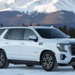 A white 2021 GMC Yukon AT4 is parked in the snow after leaving a GMC dealer near you.