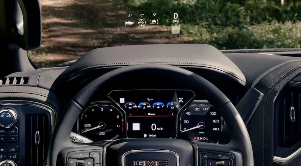 A 2021 GMC Sierra 1500 AT4 off-Road truck with heads-up display shows the steering wheel.