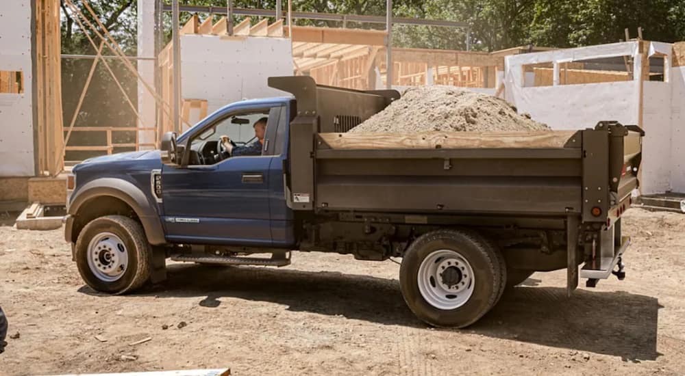 A blue used diesel truck 2020 Ford F-450 is being used as a dump-truck.