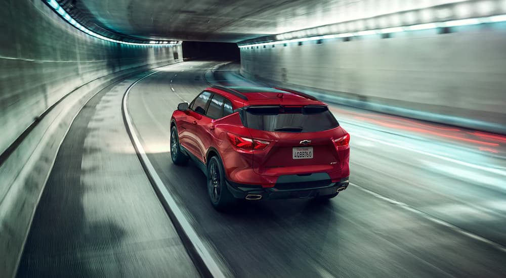 A red 2021 Chevy Blazer is shown driving through a tunnel.